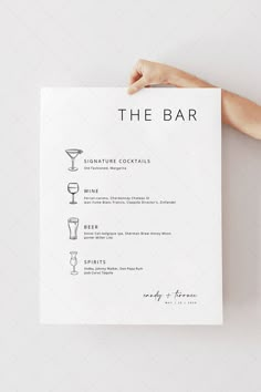 a person holding up a menu for a cocktail bar with drinks on the front and side