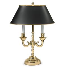 a gold lamp with a black shade on it