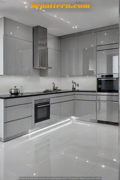 a modern kitchen with stainless steel appliances and white flooring is featured in this image