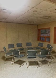 an empty conference room with blue chairs