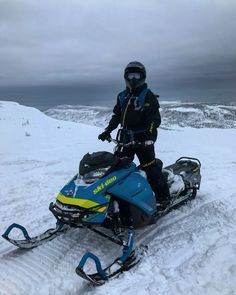 a man riding on the back of a snowmobile