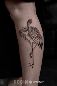 a flamingo tattoo on the right leg