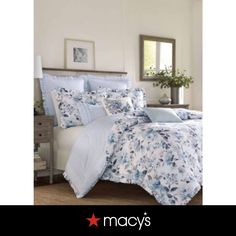 a bed with blue and white flowers on it