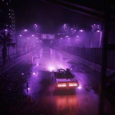 a car driving down a street at night in the rain with purple lights on it