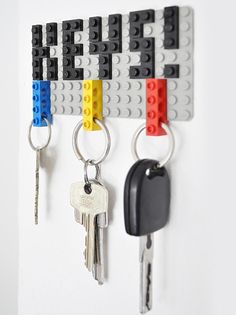 three lego key holders are hanging on the wall