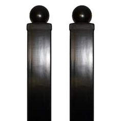 two tall black speakers sitting next to each other