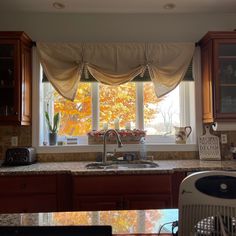 a kitchen sink under a window next to a counter