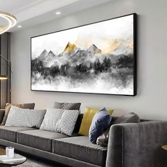 a living room filled with furniture and a large painting on the wall above it's couch