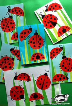 four ladybugs are shown on the green background with white papers and blue envelopes