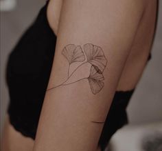 a woman's arm with a tattoo on it that has a flower in the middle