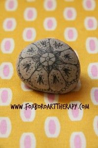 a rock sitting on top of a yellow and white polka dot table cloth with dots