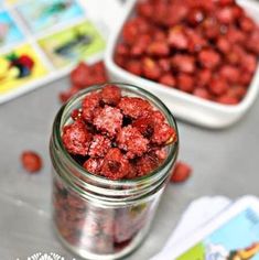 a jar filled with red food sitting on top of a table next to other items