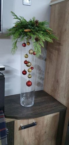 a vase filled with ornaments on top of a wooden table