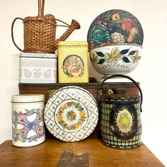 there are many decorative items on the shelf next to each other, including bowls and plates