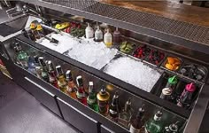 an image of a bar with bottles on it and ice cubes in the bottom drawer