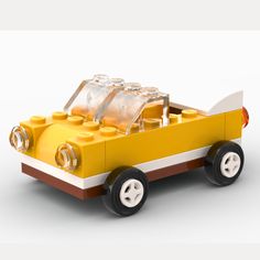 a yellow lego car is shown on a white background