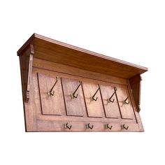 a wooden wall mounted coat rack with six hooks and five coats on the top shelf