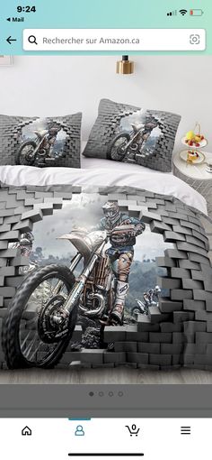 an image of a bed with a motorcycle on the cover and pillow cases in front of it