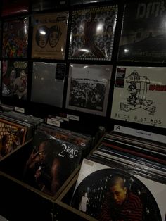 various records are on display in a music store with black and white images behind them