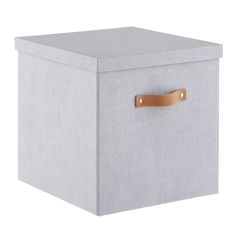 a grey storage box with leather handles and a brown handle on the front, sitting against a white background