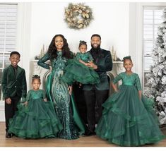 the family is dressed in green for christmas