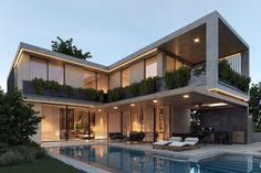 a modern house with an outdoor pool and lounge chairs in the foreground at dusk