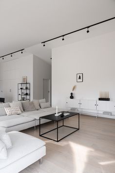 a living room filled with furniture and white walls