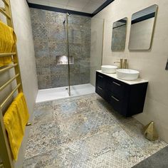 a bathroom with two sinks and a shower