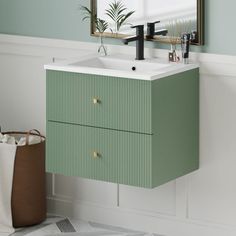 a bathroom vanity with a mirror above it and a plant on the counter next to it