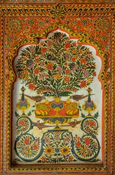 an intricately decorated wall with flowers and birds