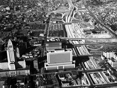 an aerial view of a city with lots of tall buildings and roads in the foreground