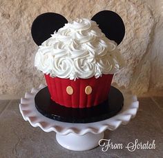 a mickey mouse cupcake with white frosting on top