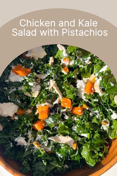 chicken and kale salad with pistachios in a wooden bowl on a table