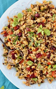 a white plate topped with rice covered in cranberry sauce and veggies