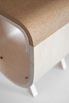 a close up of a wooden bench with white legs and wood grain on the top