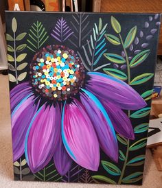 a painting of a purple flower with lots of colored confetti on it's petals