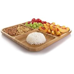 a wooden tray with rice, fruit and nuts on it