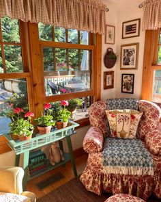 a living room filled with furniture and lots of window sill covered in pictures on the wall