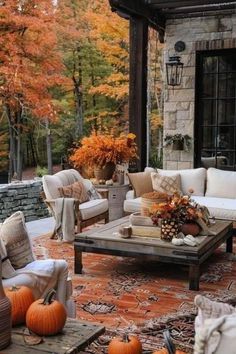 an outdoor living room is decorated with pumpkins