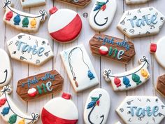 decorated cookies with fishing related designs on them sitting on a white table top next to each other