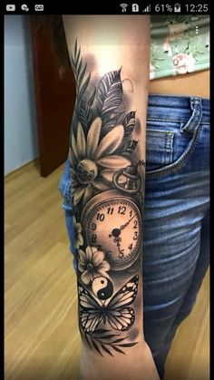 a woman's arm with a clock and flowers on it