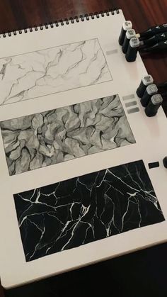 three different types of black and white art work on a table with markers, pens and pencils