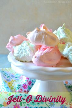 a white bowl filled with marshmallows on top of a colorful table cloth