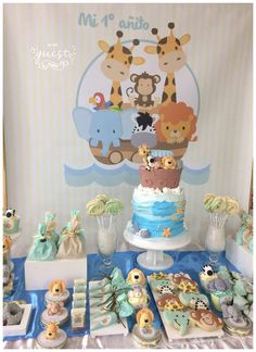 a blue and white dessert table with baby shower items