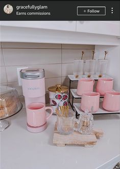 a kitchen counter with cups and mugs on it, next to an appliance