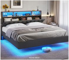 a bed that has some lights on the headboard and foot board in front of it