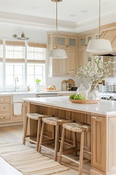 a large kitchen with wooden cabinets and stools