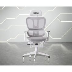 a white office chair sitting in front of a wall with hex - tech letters on it