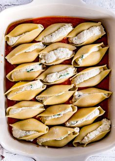 pasta shells with sauce and cheese in a casserole dish