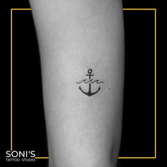 a small anchor tattoo on the leg